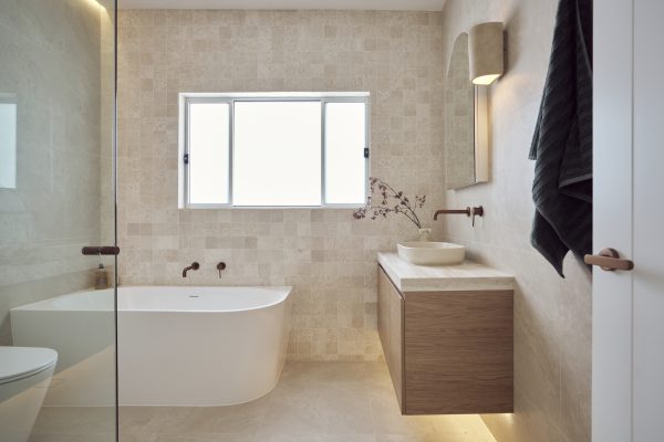 Modern Mediterranean bathroom renovation in Cronulla with curved shower screen and brushed bronze tapware
