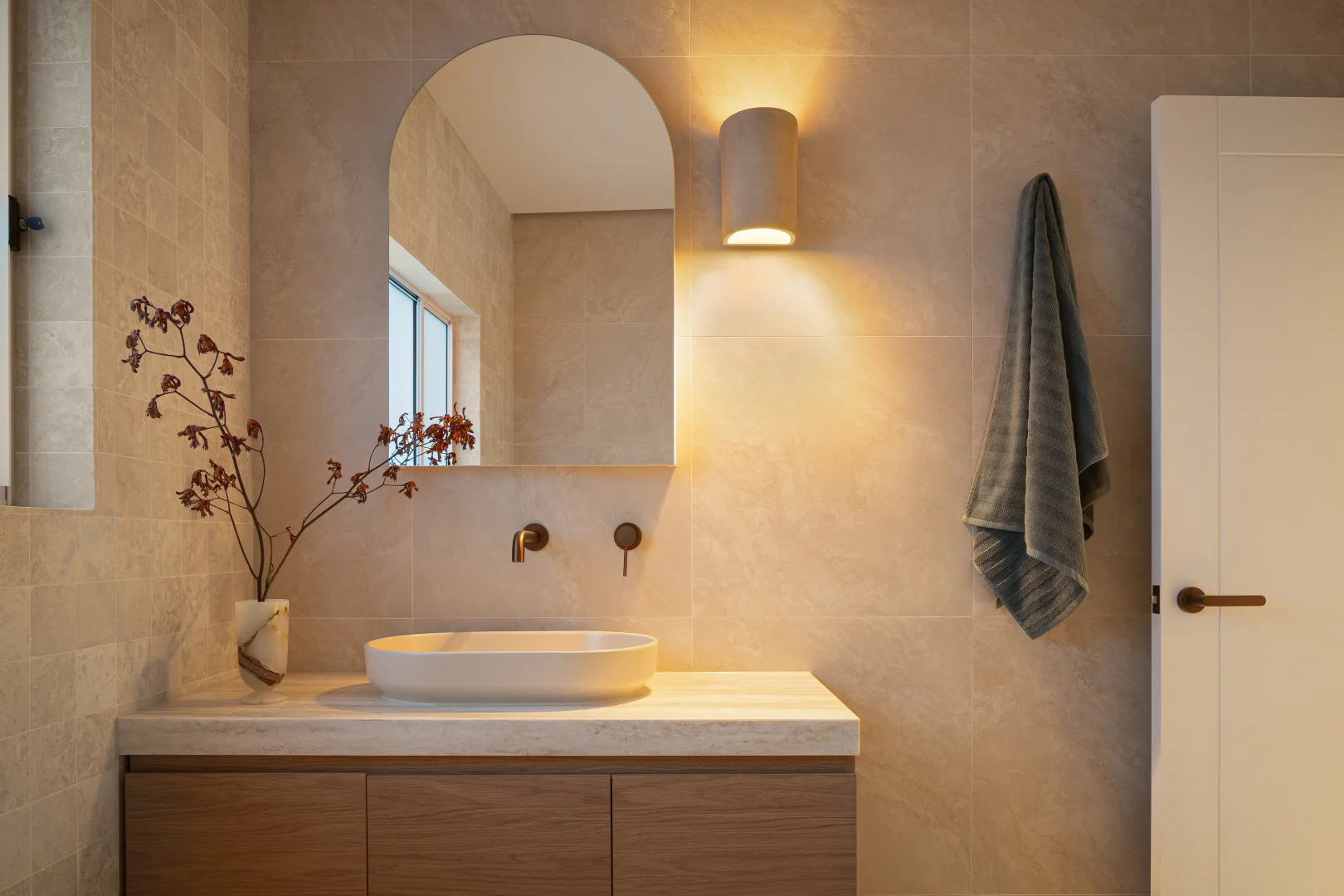 bathroom transformation with wall hung vanity and LED wall light
